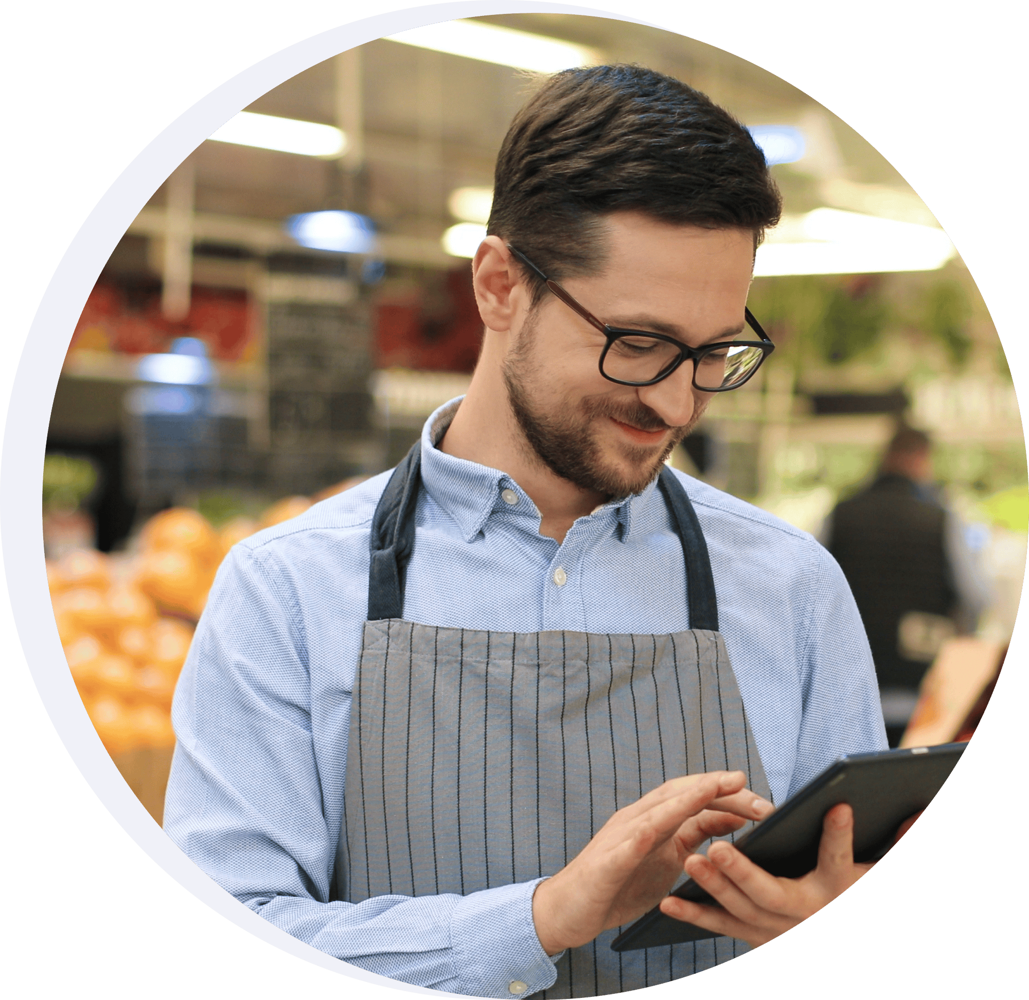 Grocery store associate looking at a tablet Grocery store associate looking at a tablet